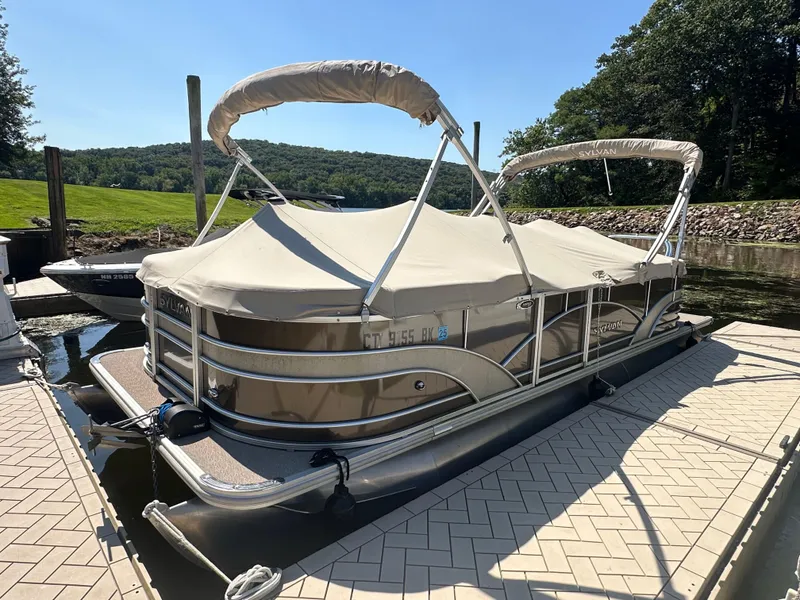 Slide: The Image of 2019 Sylvan Mirage 8522 LZ pontoon boat docked with cover on. - 13