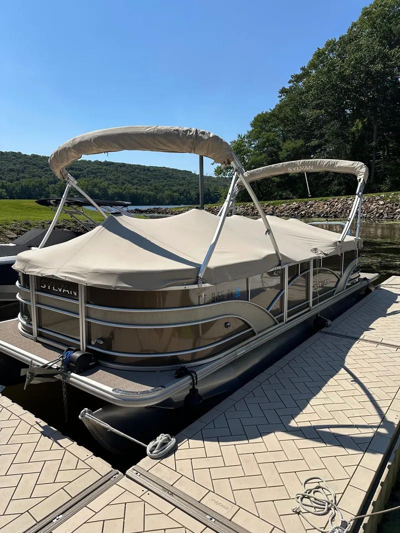 Slide: The Image of 2019 Sylvan Mirage 8522 LZ pontoon boat docked with canopy cover. - 14