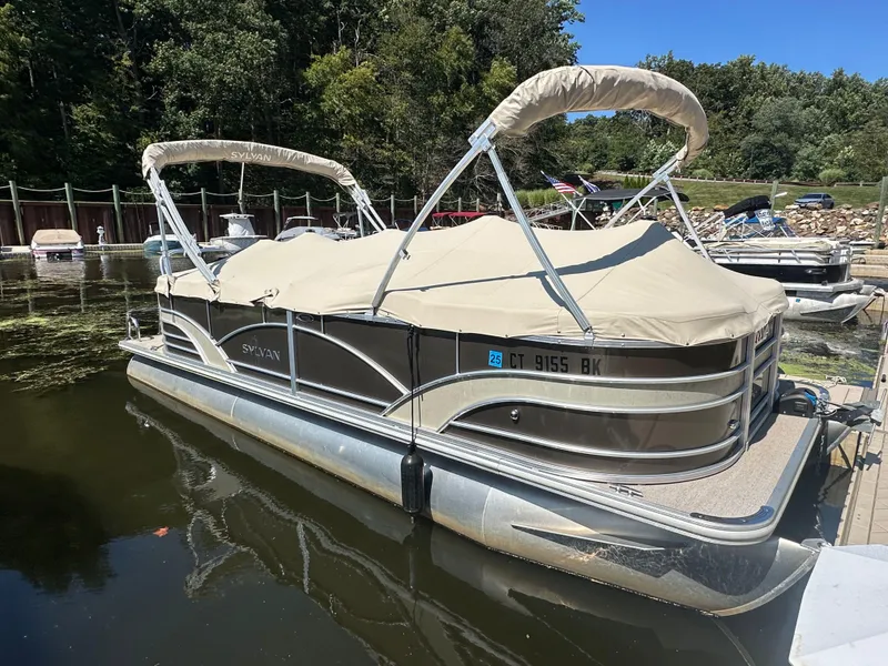 Slide: The Image of 2019 Sylvan Mirage 8522 LZ pontoon boat docked with cover on. - 15