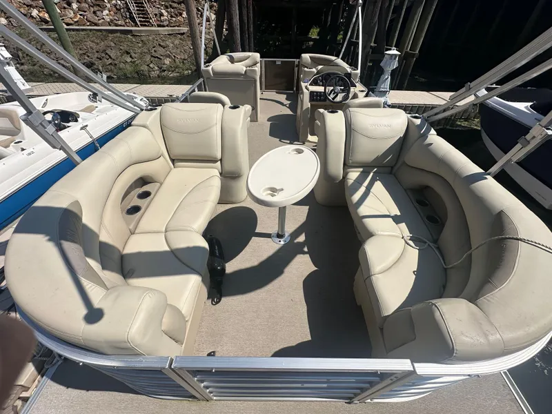 Slide: The Image of 2019 Sylvan Mirage 8522 LZ pontoon boat with spacious seating and central table. - 2