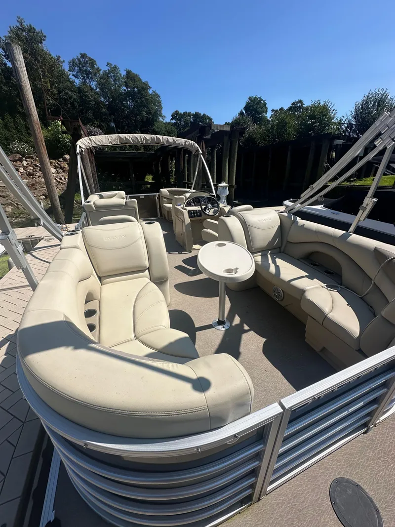 Slide: The Image of 2019 Sylvan Mirage 8522 LZ pontoon boat with beige seating and canopy, docked outdoors. - 3