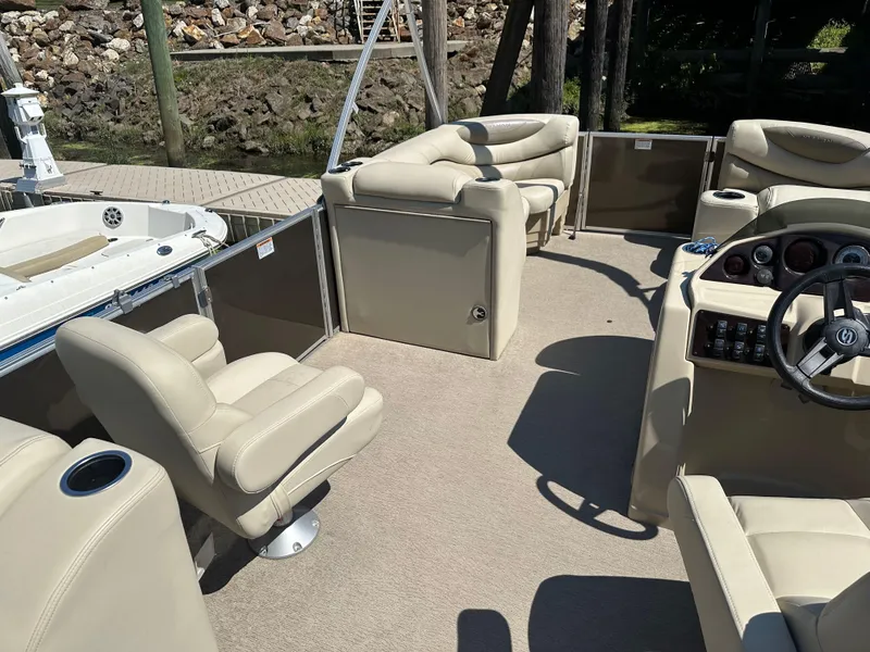 Slide: The Image of 2019 Sylvan Mirage 8522 LZ pontoon boat interior with beige seating and steering console. - 5