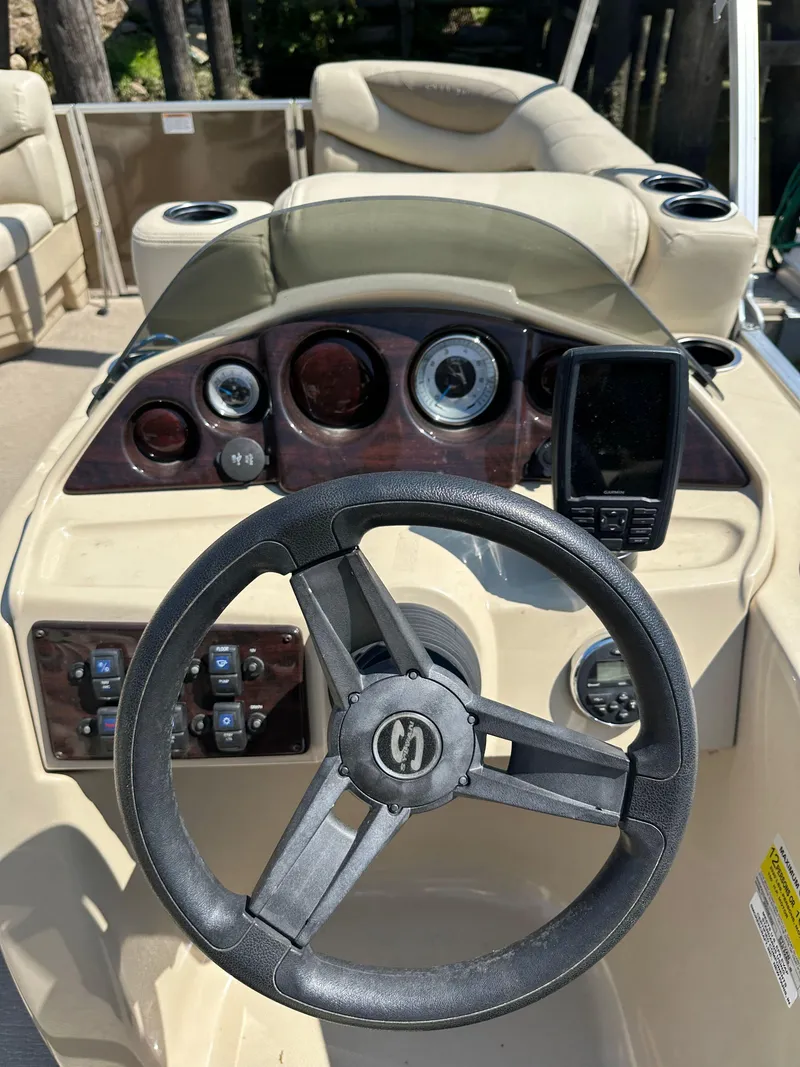 Slide: The Image of 2019 Sylvan Mirage 8522 LZ boat dashboard with steering wheel and gauges. - 6