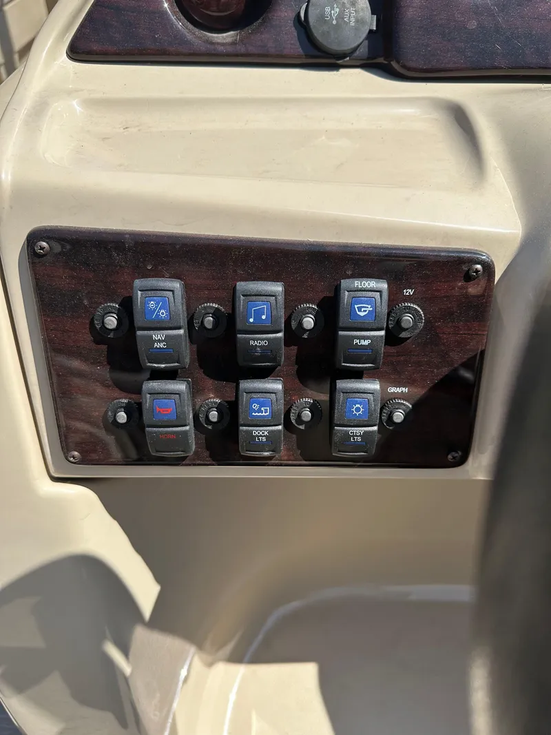 Slide: The Image of Control panel of 2019 Sylvan Mirage 8522 LZ boat with labeled switches. - 7