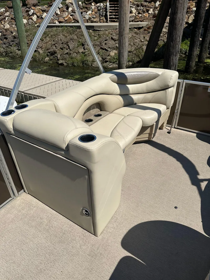 Slide: The Image of 2019 Sylvan Mirage 8522 LZ boat with beige seating and cup holders. - 9