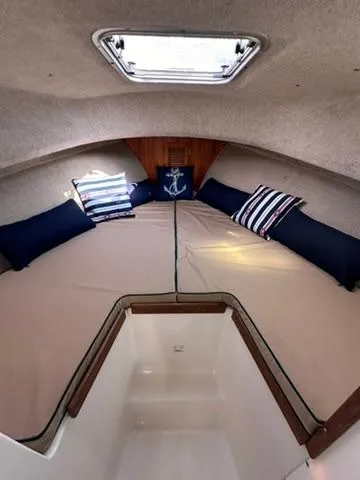 Slide: The Image of Cozy cabin interior of 1999 Atlas Boat Works Acadia 25 with nautical-themed pillows. - 13