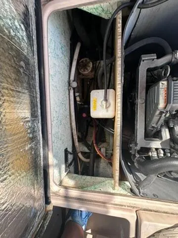 Slide: The Image of Engine compartment of 1999 Atlas Boat Works Acadia 25, showing mechanical components and wiring. - 16