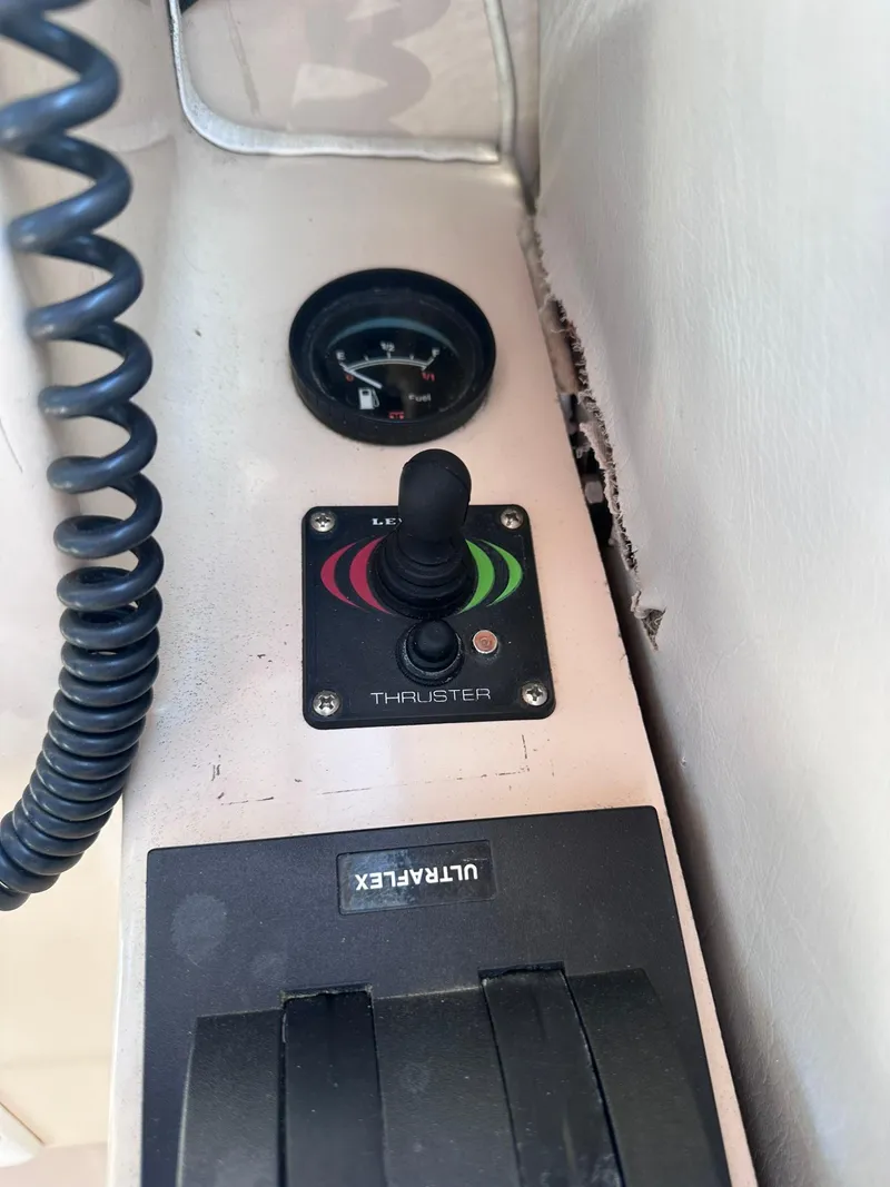 Slide: The Image of Control panel of 1999 Atlas Boat Works Acadia 25 with thruster joystick and gauge. - 19