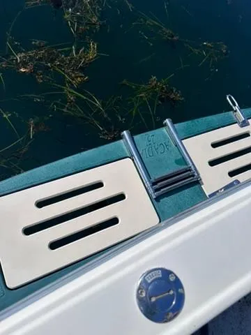 Slide: The Image of 1999 Atlas Boat Works Acadia 25 swim platform with ladder, floating on clear water. - 7