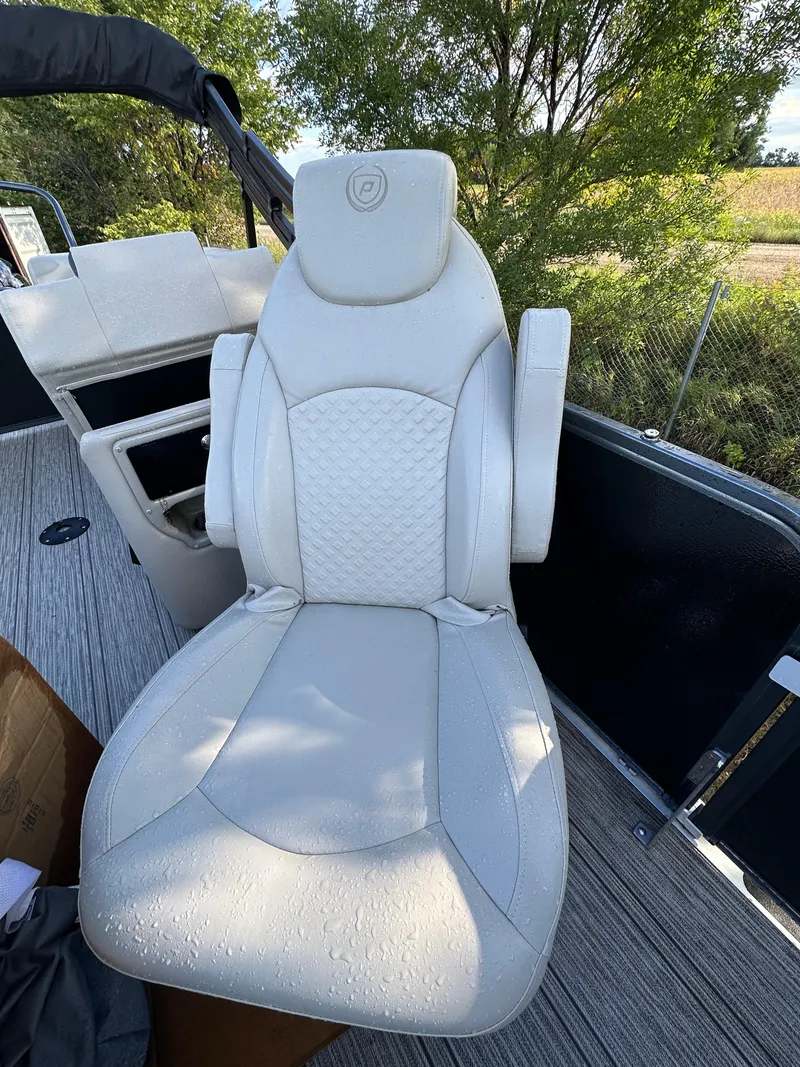 Slide: The Image of Luxurious white seat on 2022 Premier 230 SunSation RF boat, surrounded by nature. - 11
