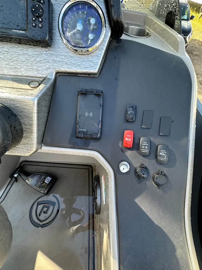 Slide: The Image of Control panel of 2022 Premier 230 SunSation RF boat with various switches and gauges. - 7