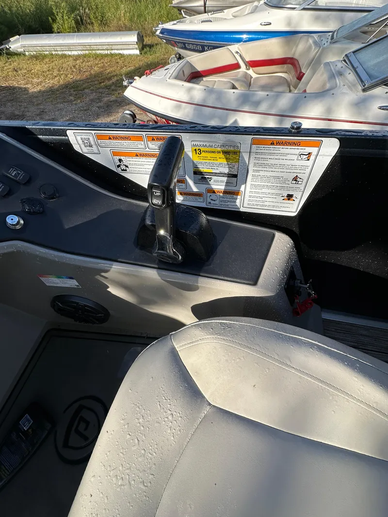 Slide: The Image of Interior view of 2022 Premier 230 SunSation RF boat with control panel and seating. - 8