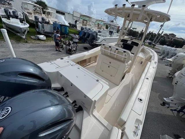 Slide: The Image of 2023 Grady-White Fisherman 257 boat with dual engines, docked at a marina. - 12