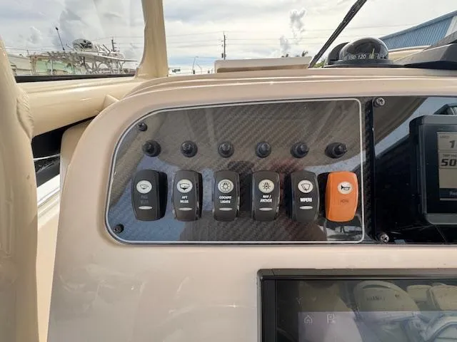 Slide: The Image of Control panel of 2023 Grady-White Fisherman 257 boat with labeled switches. - 30