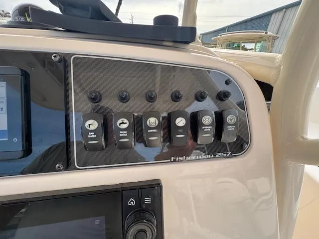 Slide: The Image of Control panel of 2023 Grady-White Fisherman 257 boat with various switches. - 31