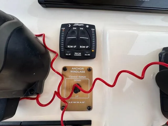 Slide: The Image of Control panel of 2023 Grady-White Fisherman 257 with anchor windlass switch and trim tab controls. - 33