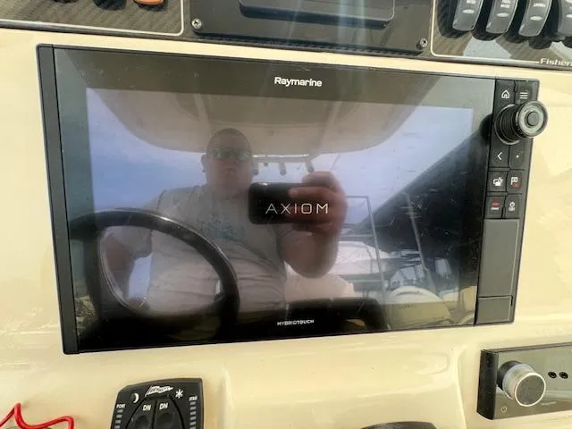 Slide: The Image of 2023 Grady-White Fisherman 257 dashboard with Raymarine Axiom display. - 34