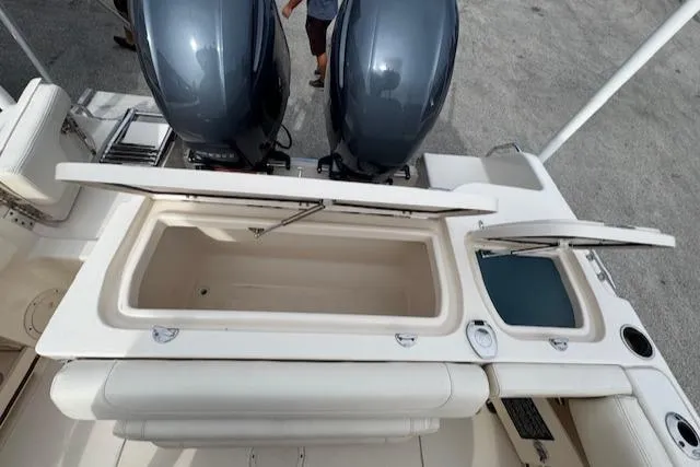Slide: The Image of 2023 Grady-White Fisherman 257 boat with open storage compartments and dual engines. - 40