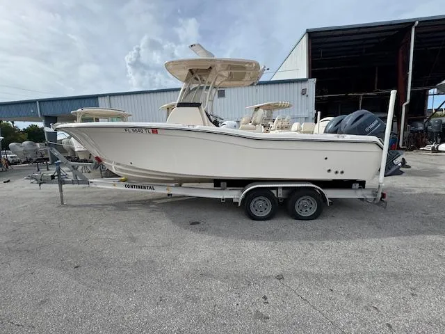 Slide: The Image of 2023 Grady-White Fisherman 257 boat on trailer, parked outside a warehouse. - 8