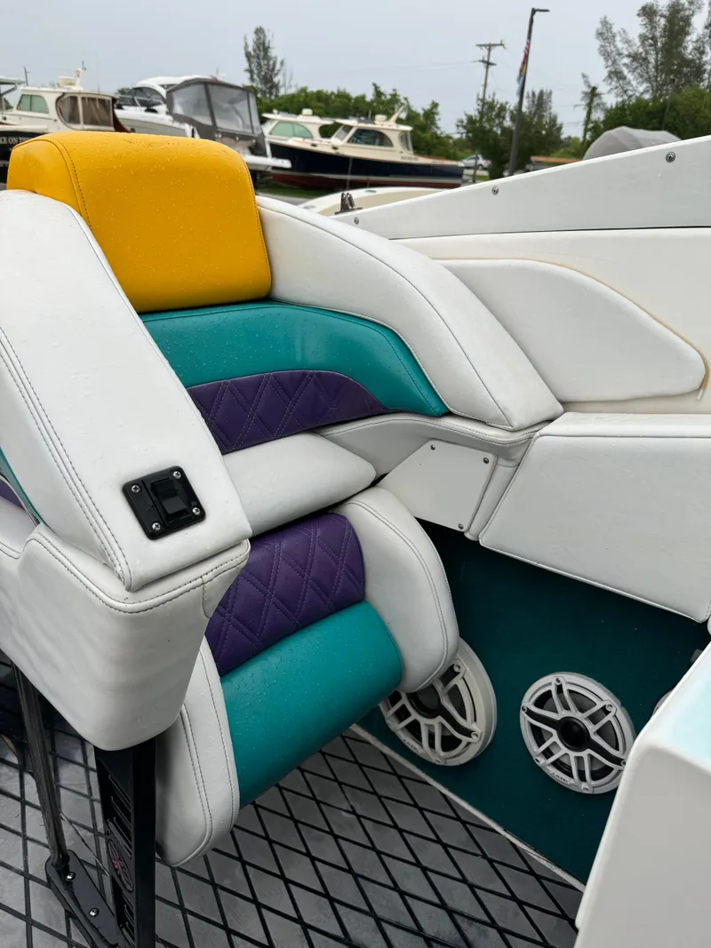 Slide: The Image of Colorful seating on a 1997 Hustler 32 boat with vibrant upholstery and speaker system. - 4