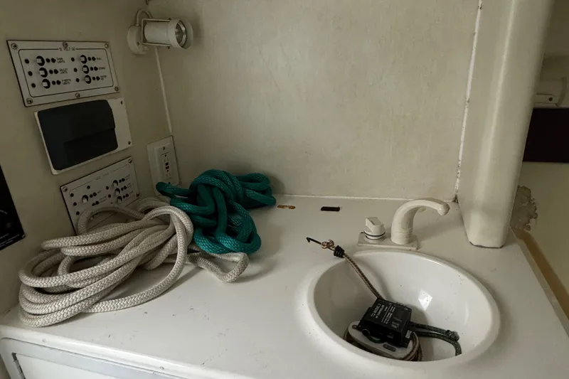 Slide: The Image of 1997 Hustler 32 boat interior with ropes and control panels. - 9