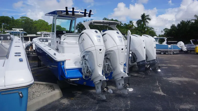 Slide: The Image of 2025 Everglades 273 CC boat with powerful outboard engines in a marina setting. - 1