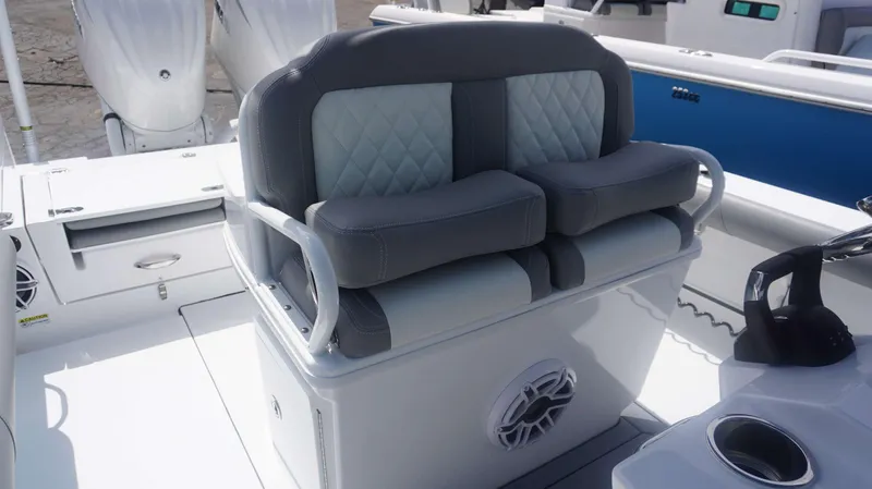 Slide: The Image of 2025 Everglades 273 CC boat interior with cushioned seating and modern design. - 11