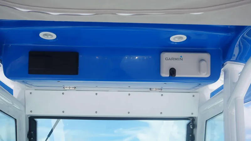 Slide: The Image of Everglades 273 CC 2025 boat interior with Garmin equipment and blue accents. - 18