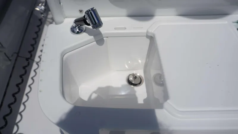 Slide: The Image of Everglades 273 CC 2025 boat sink with chrome faucet and white basin. - 21