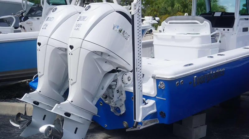 Slide: The Image of 2025 Everglades 273 CC boat with dual Yamaha outboard engines, blue hull. - 3