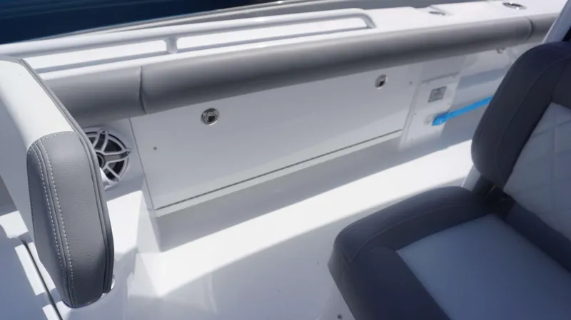 Slide: The Image of 2025 Everglades 273 CC boat interior with gray seating and speaker. - 9