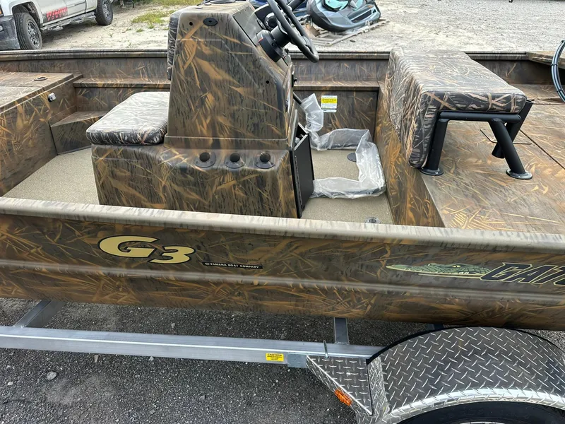 Slide: The Image of 2025 G3 Gator Tough 18 CC boat with camouflage design on a trailer. - 13