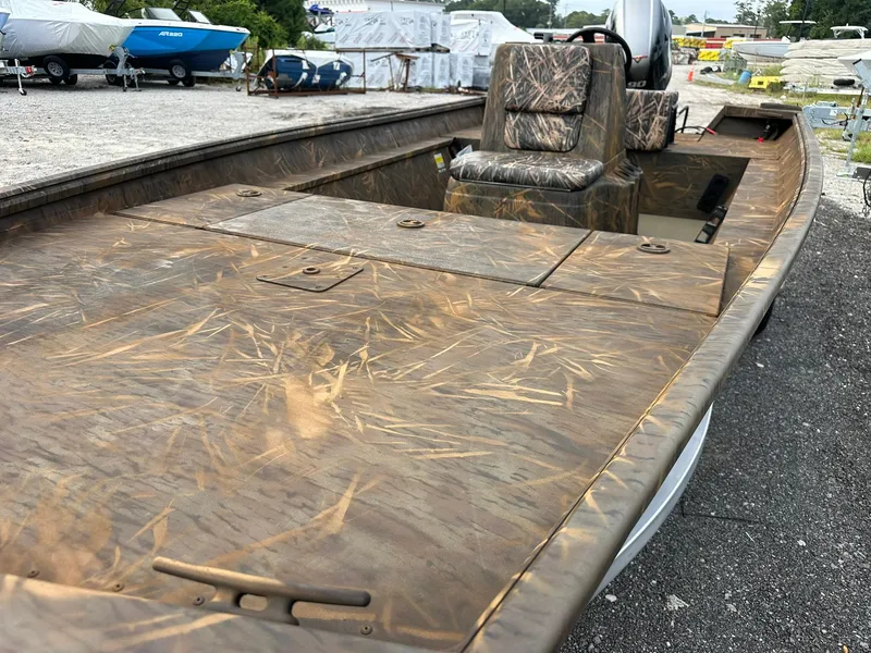 Slide: The Image of 2025 G3 Gator Tough 18 CC boat with camouflage design, parked outdoors. - 15