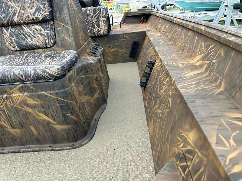 Slide: The Image of 2025 G3 Gator Tough 18 CC boat interior with camouflage seating and flooring. - 16