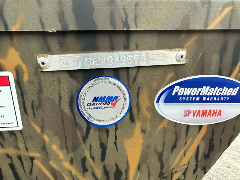 Slide: The Image of 2025 G3 Gator Tough 18 CC boat with certification and warranty stickers on camouflage exterior. - 18