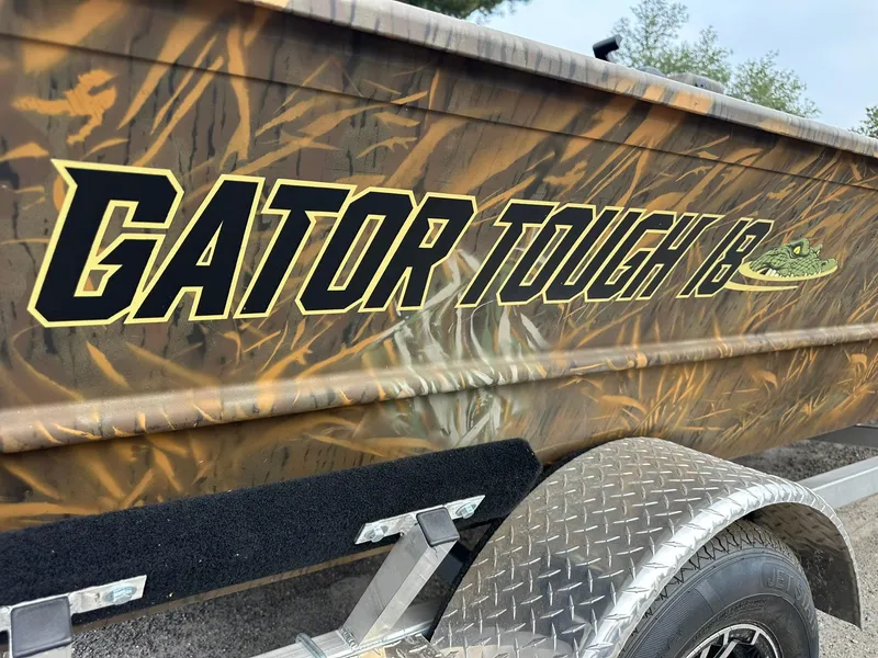 Slide: The Image of 2025 G3 Gator Tough 18 CC boat with camo design on trailer. - 9