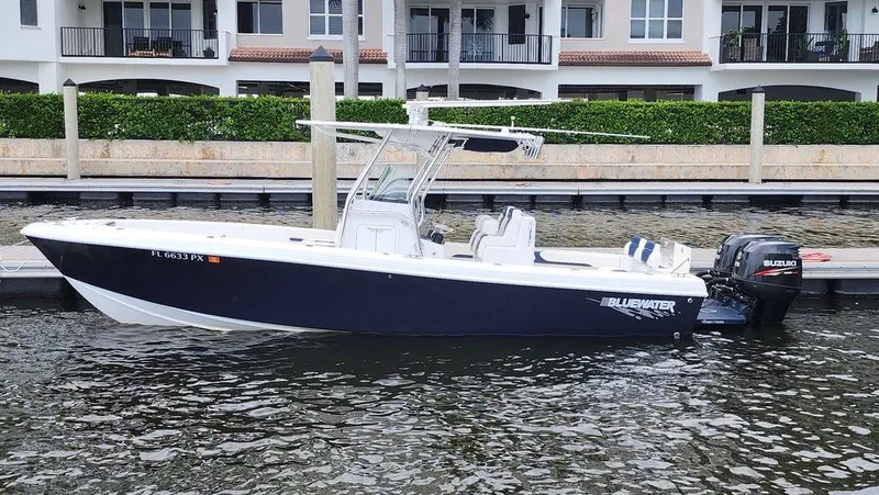 Slide: The Image of 2015 Bluewater 2550 boat docked by waterfront homes. - 1