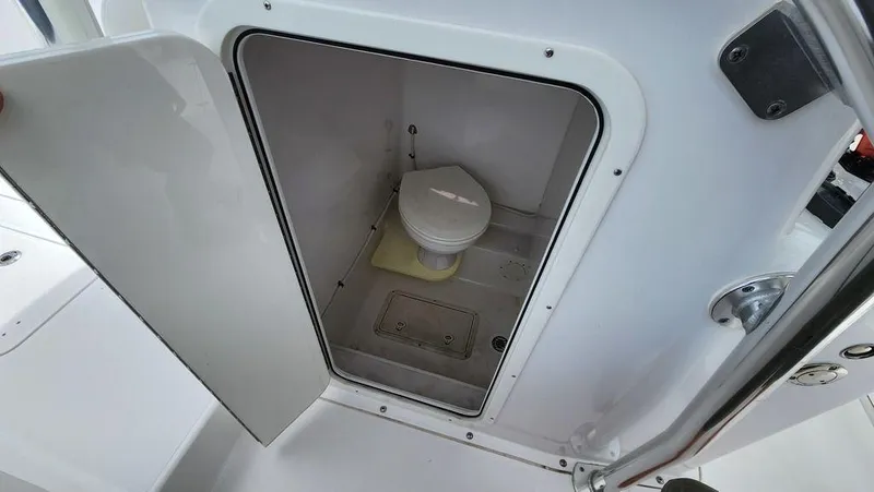 Slide: The Image of 2015 Bluewater 2550 boat interior with compact marine toilet. - 19
