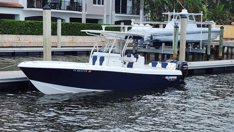 Slide: The Image of 2015 Bluewater 2550 boat docked at marina, featuring sleek design and modern amenities. - 2