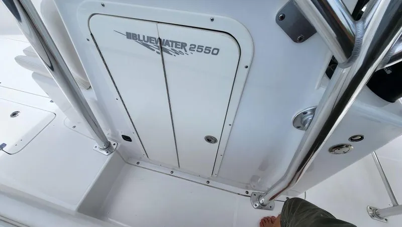 Slide: The Image of 2015 Bluewater 2550 boat interior with storage compartment and sleek design. - 20