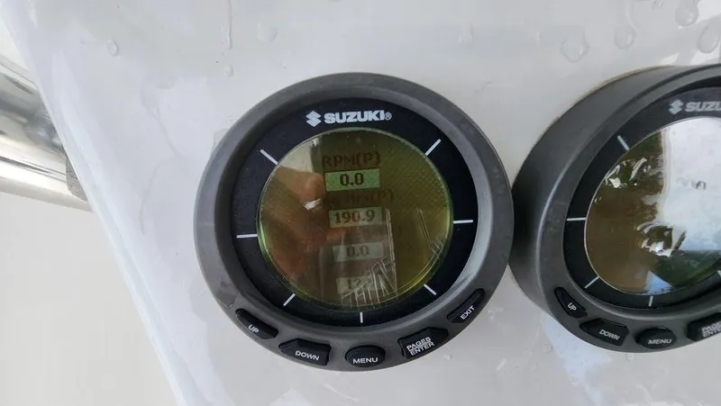 Slide: The Image of Suzuki digital gauges on a 2015 Bluewater 2550 boat dashboard. - 24
