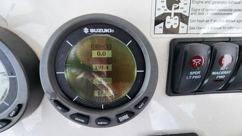 Slide: The Image of Suzuki gauge on 2015 Bluewater 2550 boat dashboard displaying RPM and other metrics. - 25