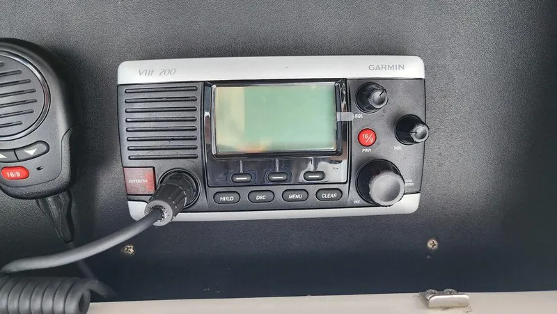 Slide: The Image of Garmin VHF 200 marine radio on a 2015 Bluewater 2550 boat dashboard. - 26