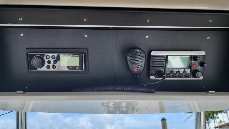 Slide: The Image of Boat electronics panel on a 2015 Bluewater 2550, featuring communication devices. - 27
