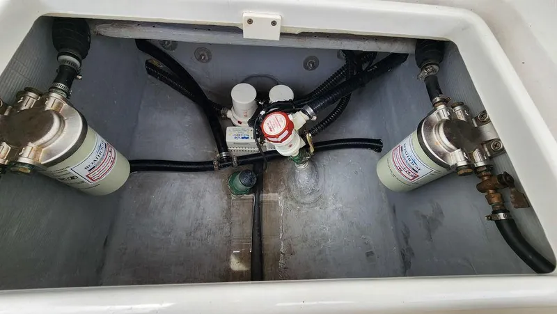 Slide: The Image of Engine compartment of 2015 Bluewater 2550 boat with fuel filters and hoses. - 29