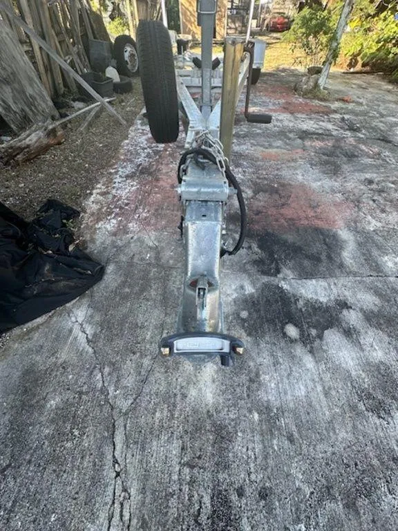 Slide: The Image of 2015 Bluewater 2550 boat trailer on a weathered concrete surface. - 32