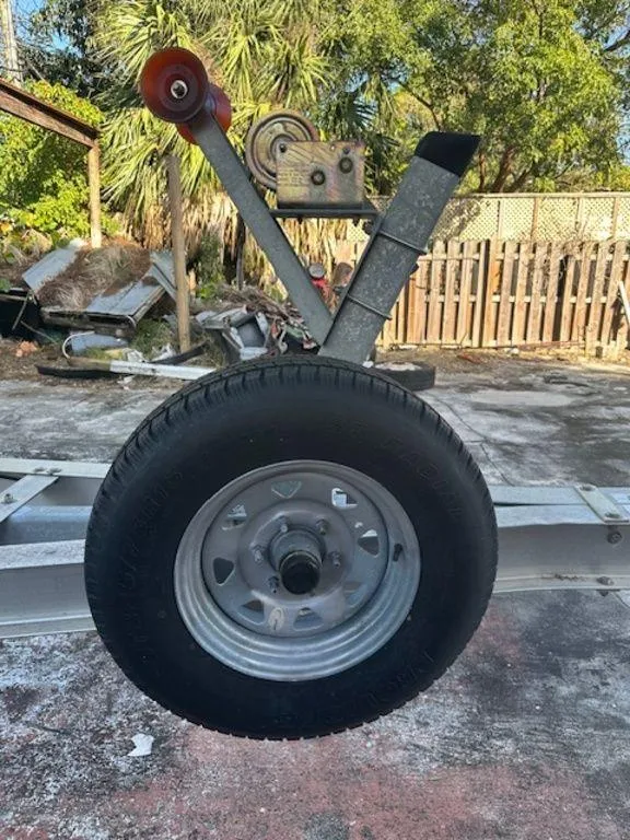 Slide: The Image of Trailer wheel and winch assembly for 2015 Bluewater 2550 boat, outdoors. - 33