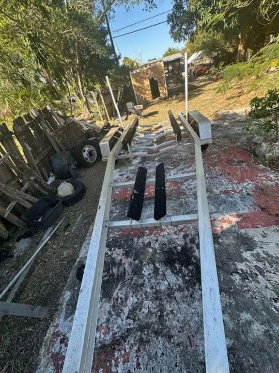 Slide: The Image of Boat trailer for 2015 Bluewater 2550, parked outdoors on a rustic surface. - 34