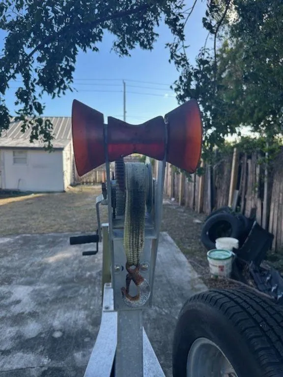 Slide: The Image of Boat trailer winch with strap, Bluewater 2550, 2015 model, in a yard setting. - 35