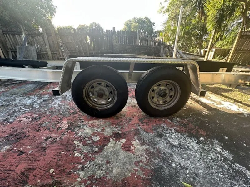 Slide: The Image of 2015 Bluewater 2550 trailer with dual wheels on a weathered surface. - 36